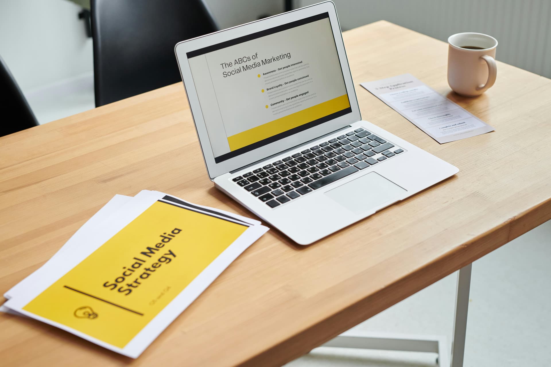 A laptop on a table displaying a social media strategy for law firms