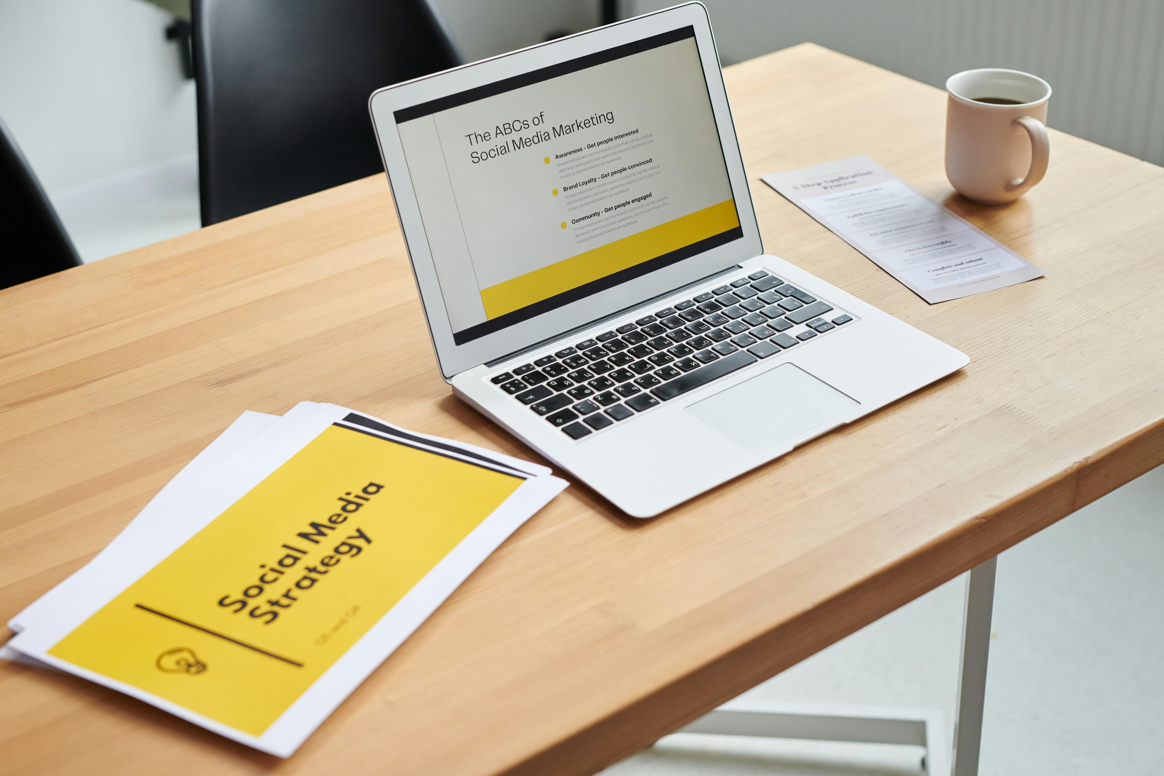 A laptop on a table displaying a social media strategy for law firms