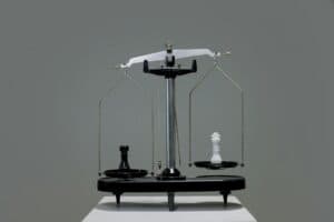 Chess pieces on a scale representing Cosmolex vs. PCLaw